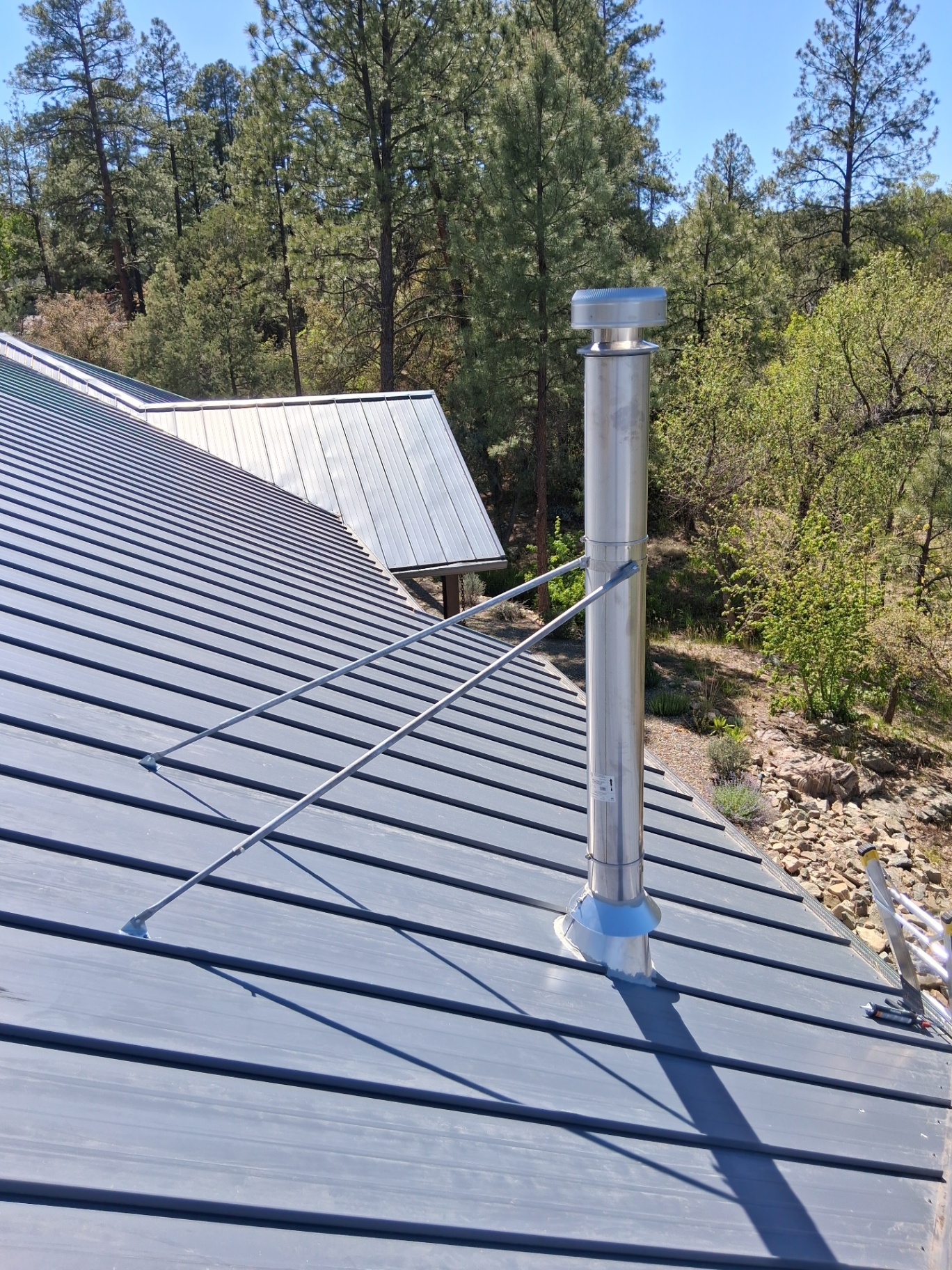 Stainless steel chimney pipe installed through metal roof in Prescott AZ